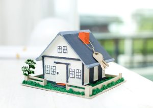 Real estate agent with house model and keys